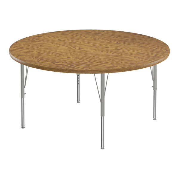 A round wooden table with silver metal legs.