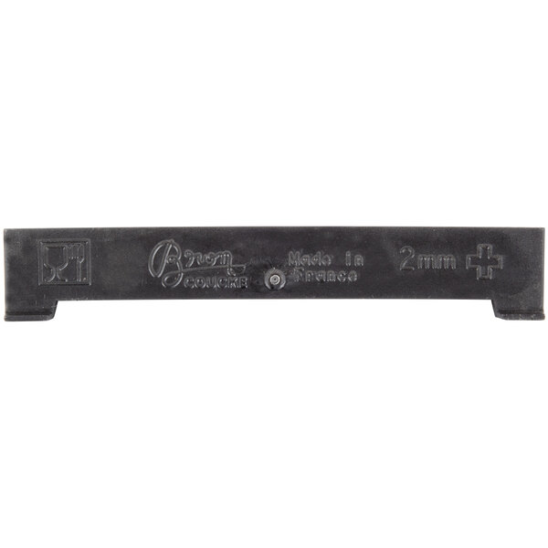 A black plastic Bron Coucke cutting blade with writing on it.