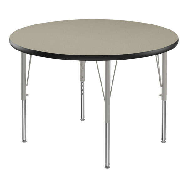 A round Correll activity table with black T-molded edges and silver legs.