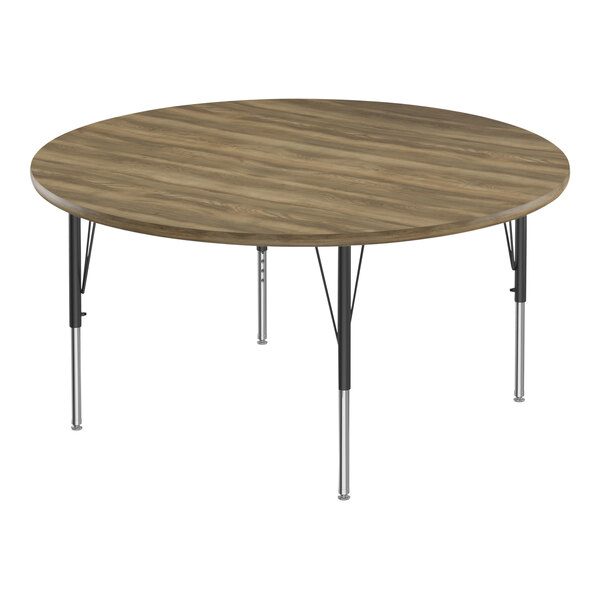 A round wooden table with black metal legs.