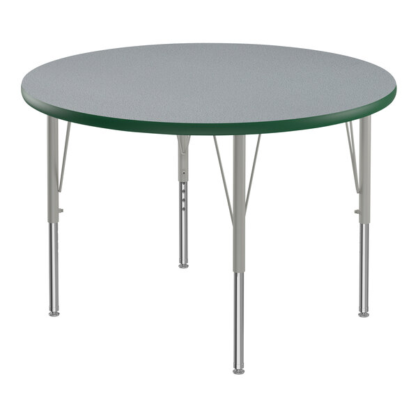 A Correll round table with a gray and green top and metal legs.