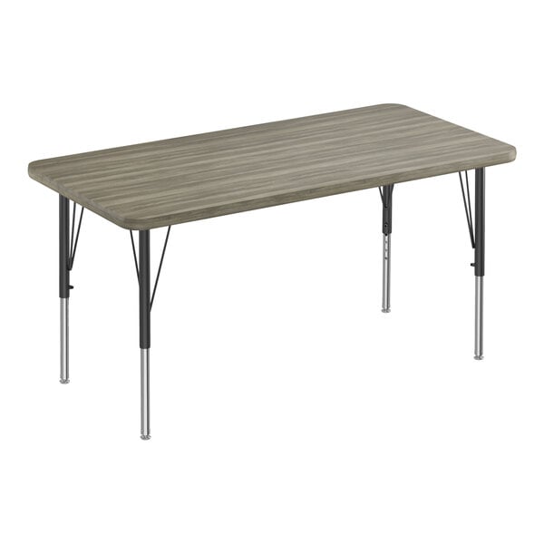 A rectangular Correll activity table with black metal legs and a gray driftwood top with driftwood T-mold.