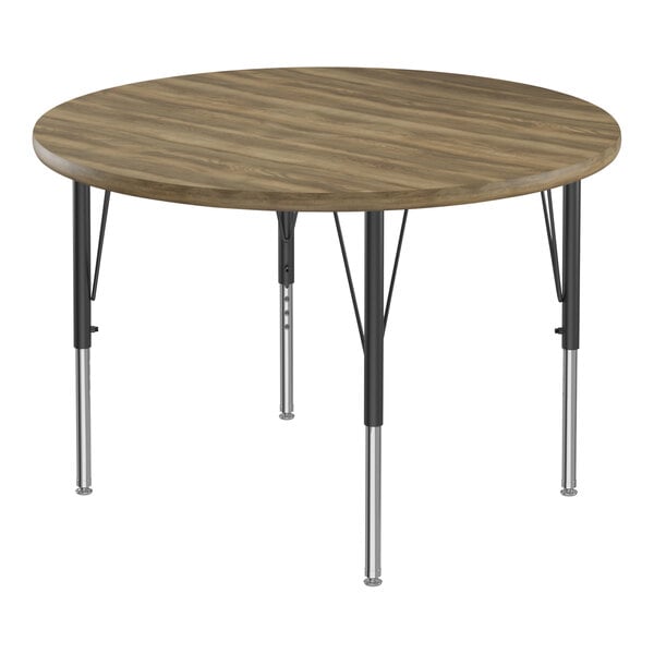 A Correll round activity table with hickory top and black legs.