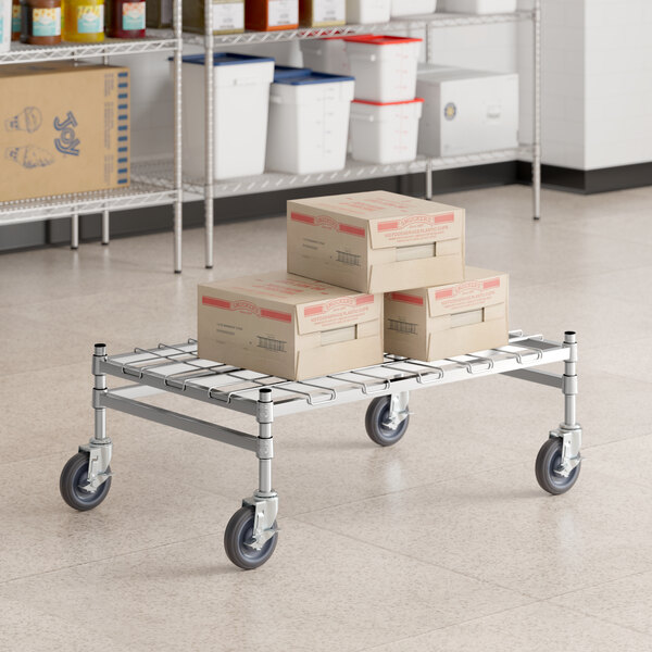 A Regency stainless steel wire mobile dunnage rack with boxes on it.