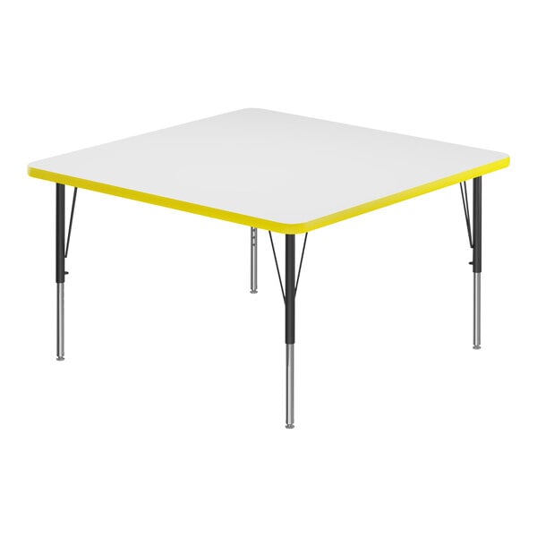 A white square activity table with yellow trim.