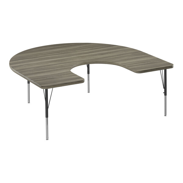 A half-moon shaped New England Driftwood activity table with metal legs.