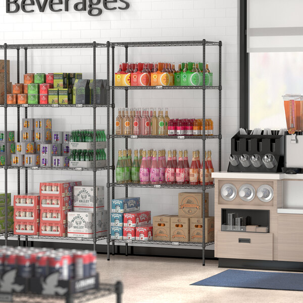 Regency black wire shelving with 5 shelves holding beverages and boxes.