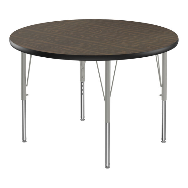 A Correll round activity table with silver metal legs and black T-mold.