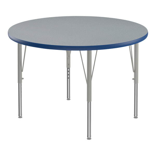 A round Correll activity table with a blue T-Mold and metal legs.