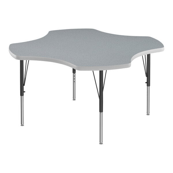 A grey table with a white and grey clover shaped top and black legs.