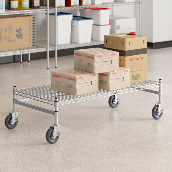 A Regency stainless steel wire dunnage rack with boxes on it.
