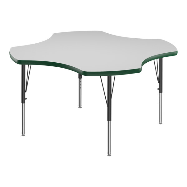 A white table with a green edge and green T-mold on a Correll activity table.