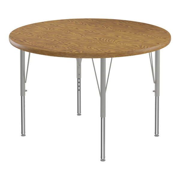 A close-up of a Correll round wooden activity table with silver legs.