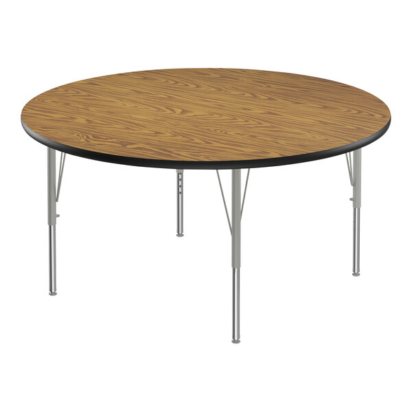 A Correll round activity table with metal legs and a medium oak top.