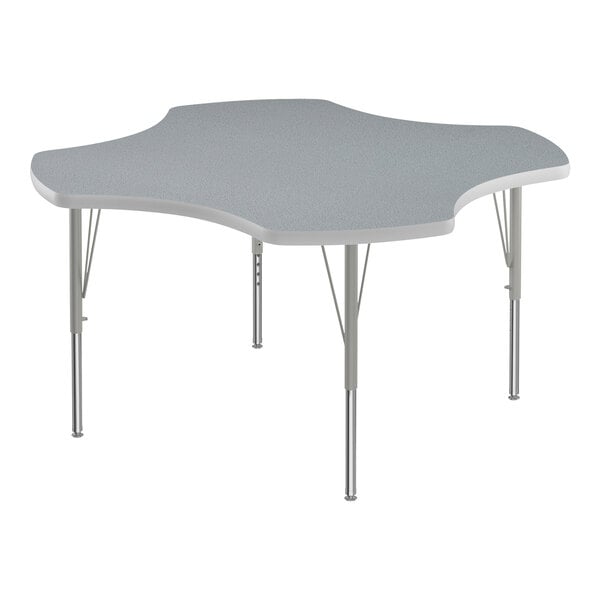 A gray table with a gray and white clover-shaped top and silver legs.