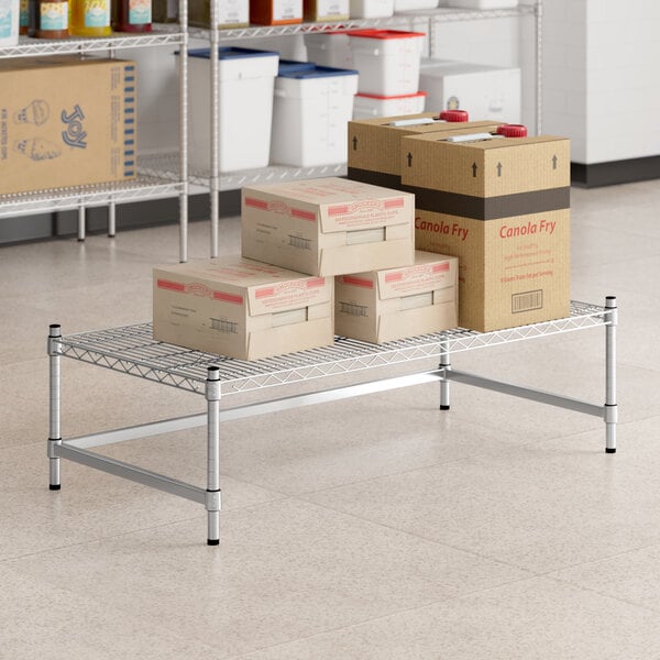 A group of white boxes on a Regency stainless steel wire shelf.