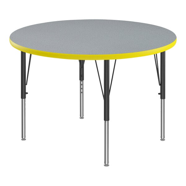 A Correll round activity table with a gray and yellow top.