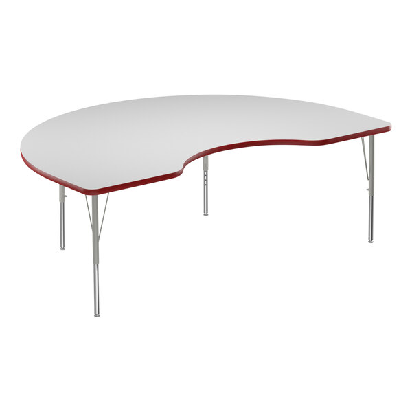 A white Correll kidney-shaped activity table with a red edge and metal legs.