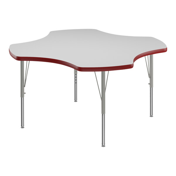 A white table with a red clover-shaped top and red trim on white table legs.