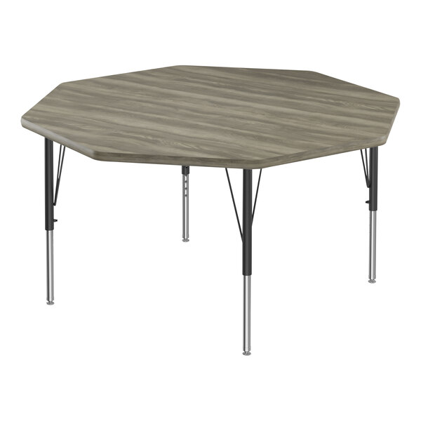 A Correll New England Driftwood octagon activity table with black metal legs.