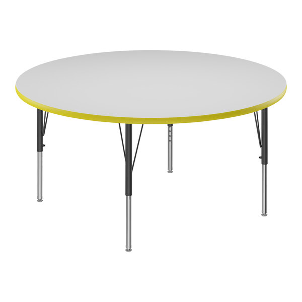 A white round table with a yellow trim and black metal base.