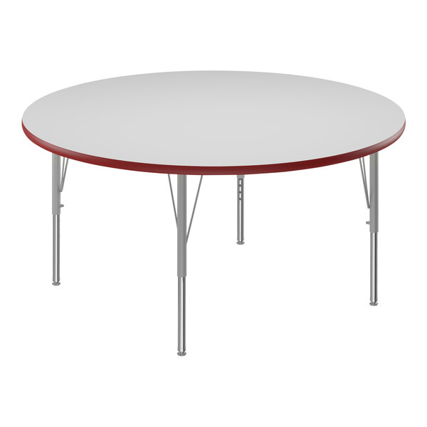 A white round Correll activity table with red edges.