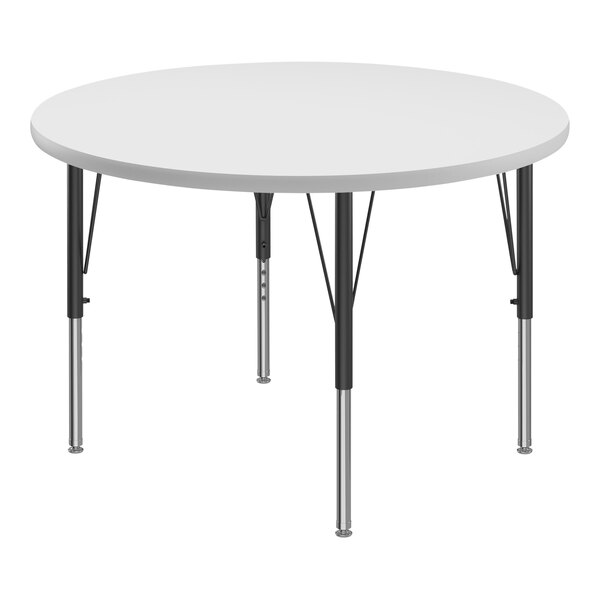 A white round Correll activity table with black metal legs.