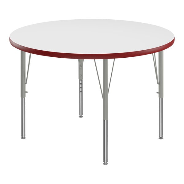 A white round Correll activity table with red edges.