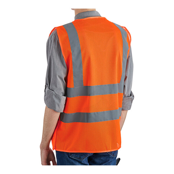 A person wearing a Lavex orange high visibility safety vest with reflective stripes.