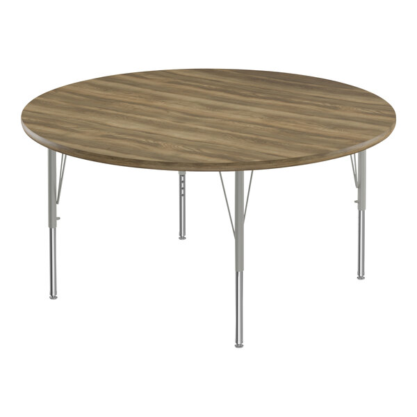 A round wooden Correll activity table with metal legs.