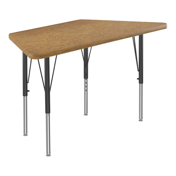 A trapezoid shaped Correll activity table with medium oak top and black legs.