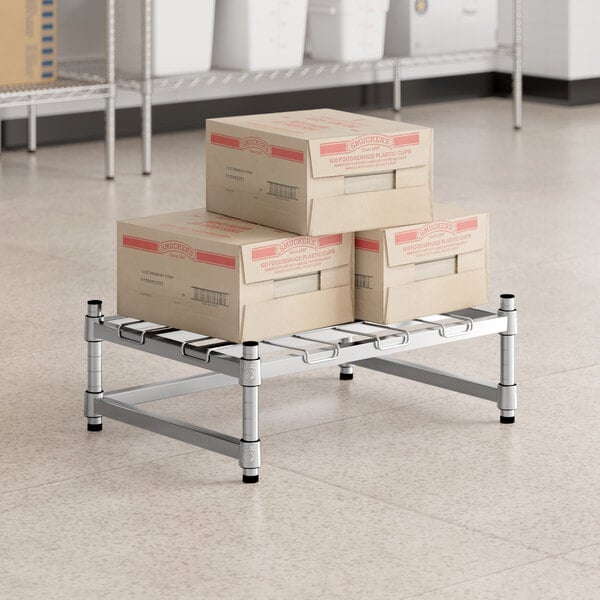 A stack of boxes on a Regency stainless steel wire dunnage rack.