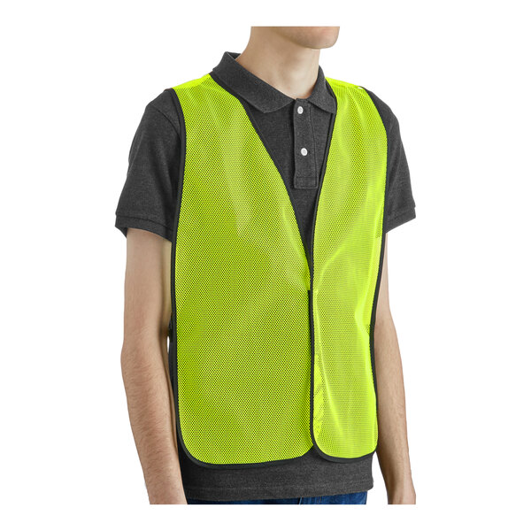 A person wearing a lime green high visibility safety vest.