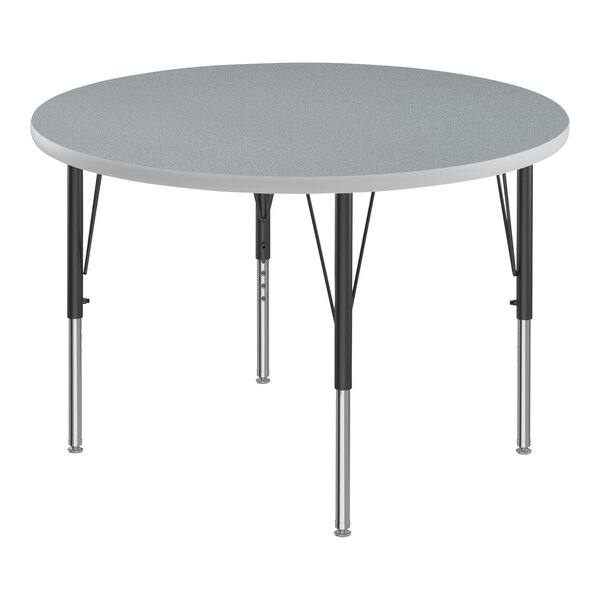 A Correll round activity table with gray top and black legs.