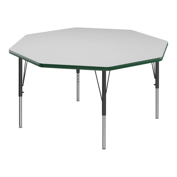 A white hexagon Correll activity table with black legs and green T-mold.