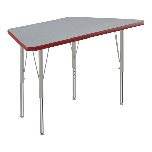 A grey high-pressure laminate trapezoid table with red trim.