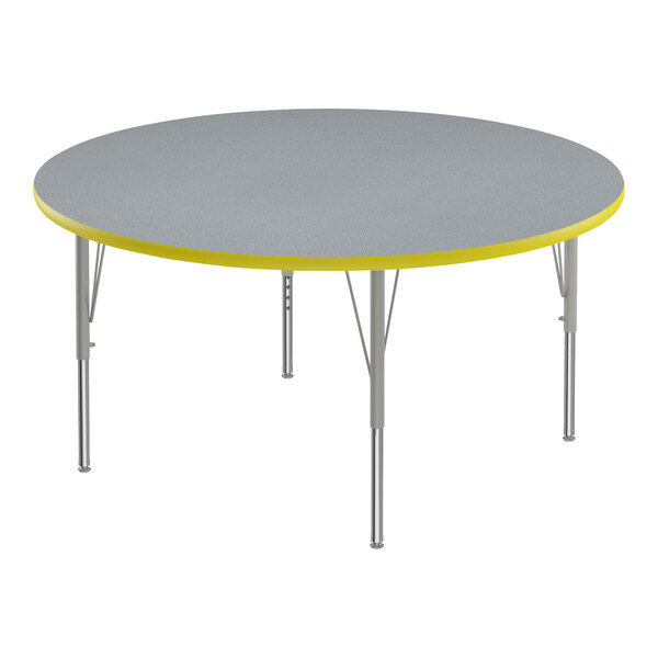 A round grey high-pressure laminate activity table with yellow T-mold.