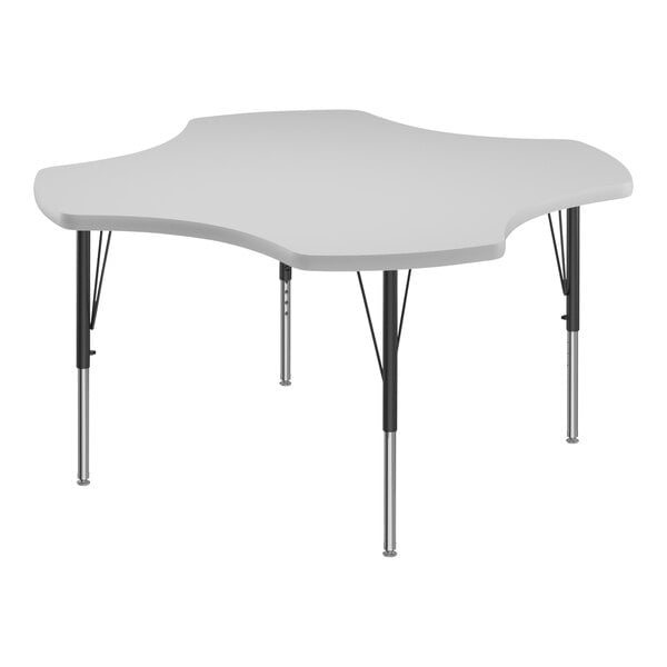 A white table with a clover-shaped top and black legs.