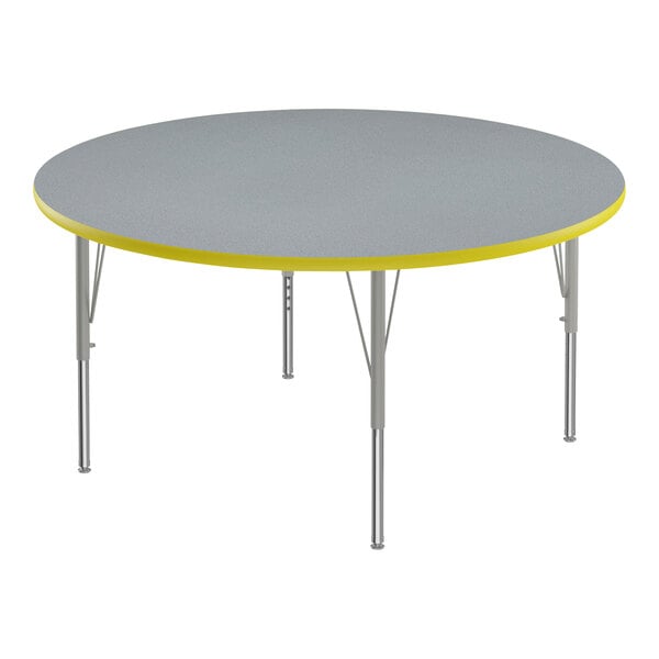 A round grey table with yellow T-mold on the edge.