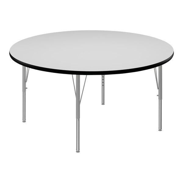 A round white table with black edges and metal legs.