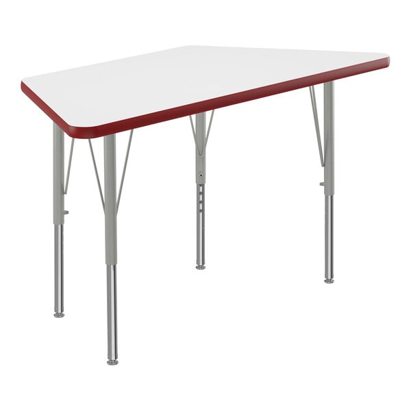 A white trapezoid-shaped table top with red edges on a table with metal legs.