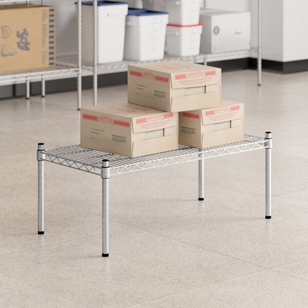 A group of boxes on a Regency stainless steel wire shelf.