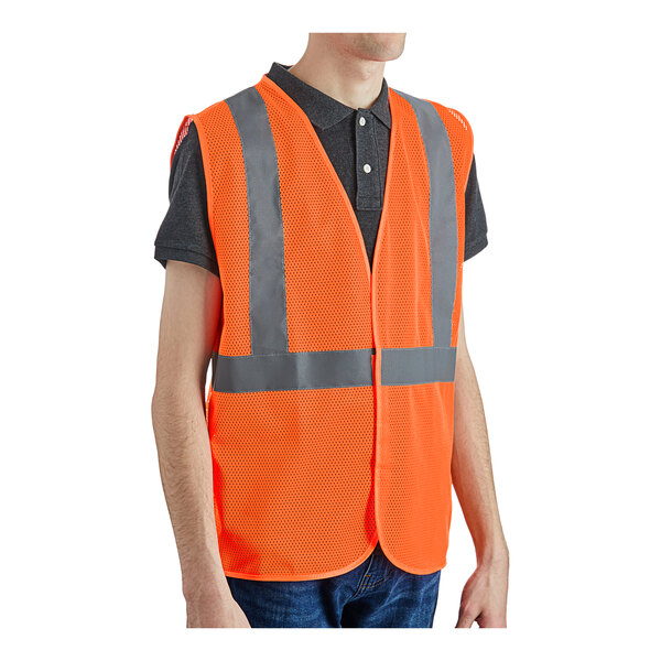 A person wearing a Lavex orange safety vest with reflective stripes.