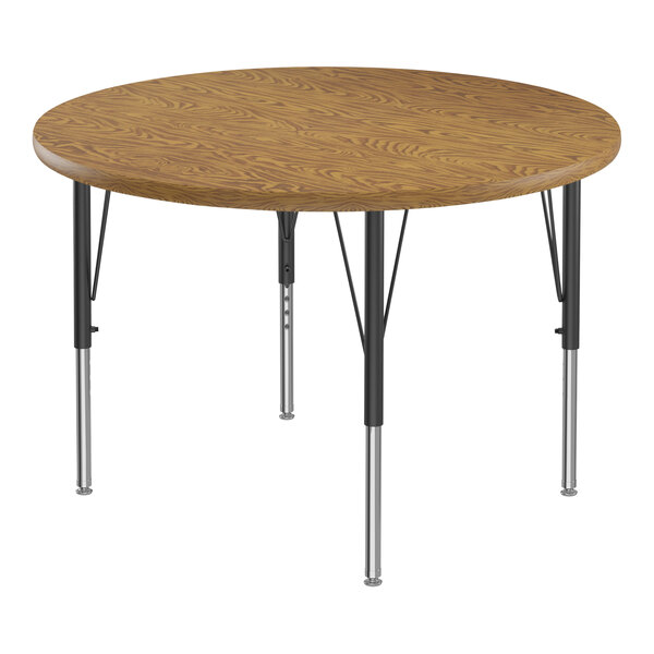 A Correll round activity table with medium oak wooden top and black metal legs.
