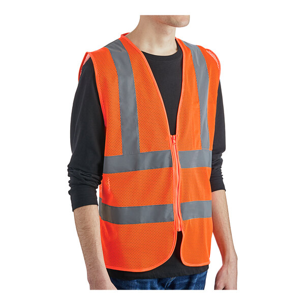 A person wearing an orange Lavex Class 2 high visibility safety vest with reflective stripes.