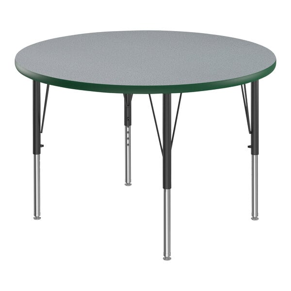 A Correll round activity table with a gray thermal-fused laminate top and green T-mold on black legs.
