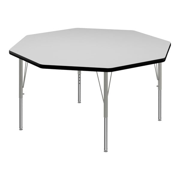 A white hexagon Correll activity table with black edges and silver legs.