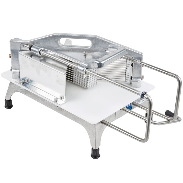 A Vollrath tomato slicer with a metal frame and safety guard.
