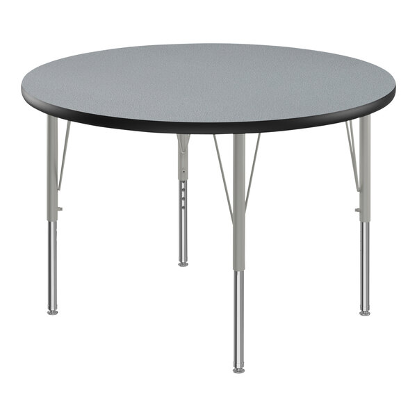 A round Correll activity table with silver legs and black T-Mold.