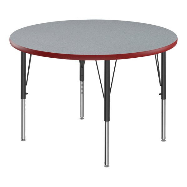 A Correll round activity table with a gray top and red T-molded legs.